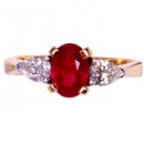 18ct Ruby Ring. An Oval Ruby and Diamond Three Stone Ring. 18ct Ruby Ring. An Oval Ruby and Diamond Three Stone Ring.