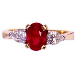 18ct Ruby Ring. An Oval Ruby and Diamond Three Stone Ring.