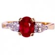 18ct Ruby Ring. An Oval Ruby and Diamond Three Stone Ring.