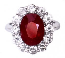 A White Gold Oval Ruby and Diamond Cluster Ring. 18kt.