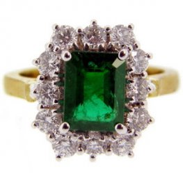 Traditional Emerald cluster ring brilliant cut diamonds.