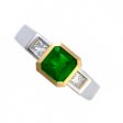 An Emerald-Cut Emerald & Diamond Three Stone Ring.